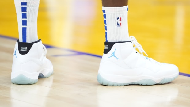 White and blue Air Jordan 11 shoes.